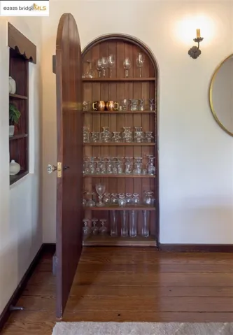Wine cellar featuring dark wood-type flooring and baseboards