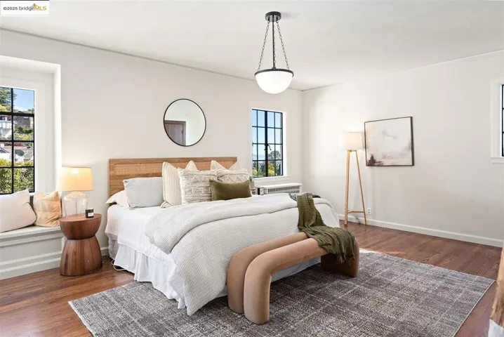 Bedroom with wood finished floors and baseboards