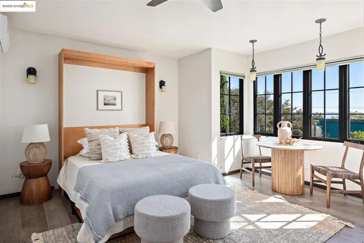 Bedroom with wood finished floors and a ceiling fan