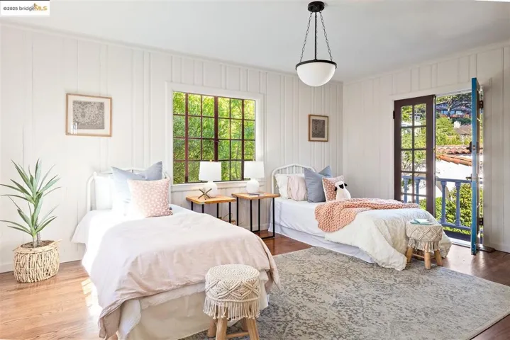 Bedroom featuring wood finished floors and access to exterior