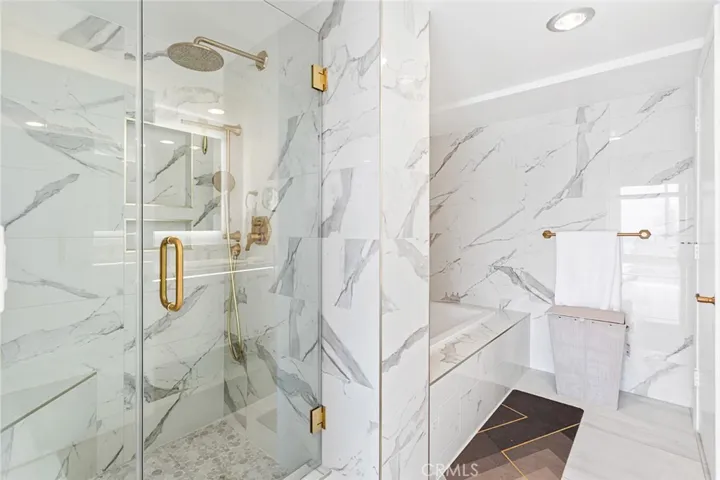 Primary bathroom with walk in shower and programmable jacuzzi tub with piped in music