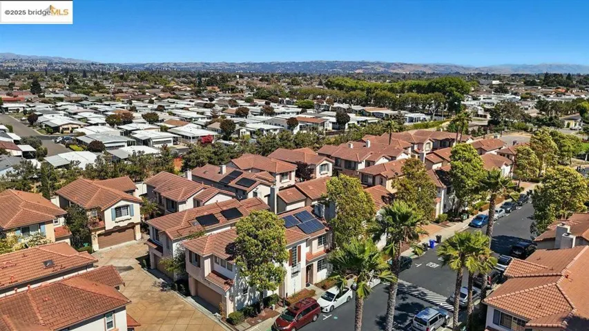 Aerial perspective of suburban area with a mountainous background