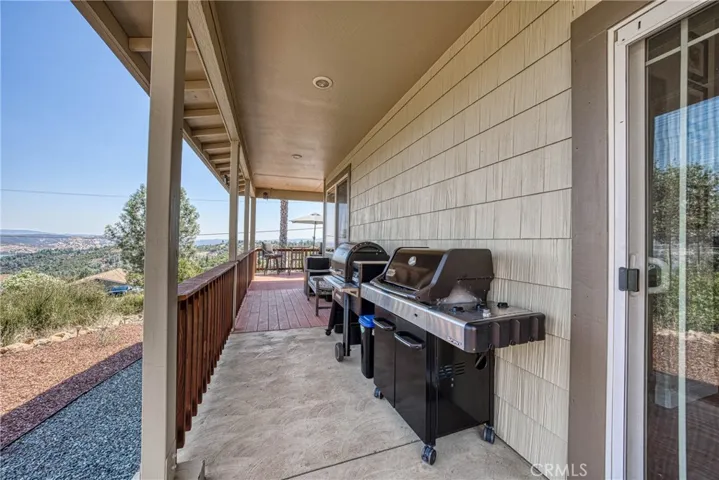 Side patio/BBQ area off dining room.