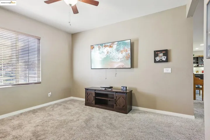 Home office featuring carpet flooring and a ceiling fan