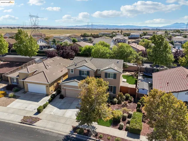 Aerial perspective of suburban area featuring a mountainous background