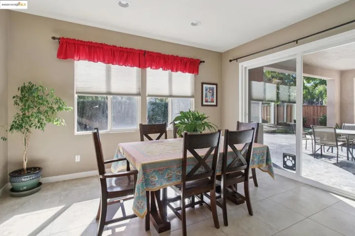 Dining area featuring light tile patterned floors and recessed lighting