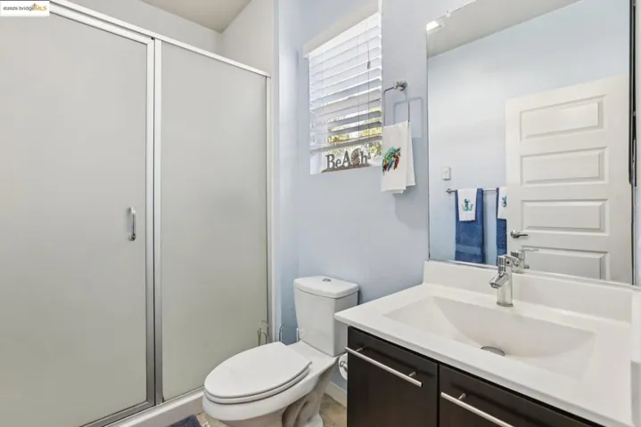 Full bathroom with vanity and a shower stall