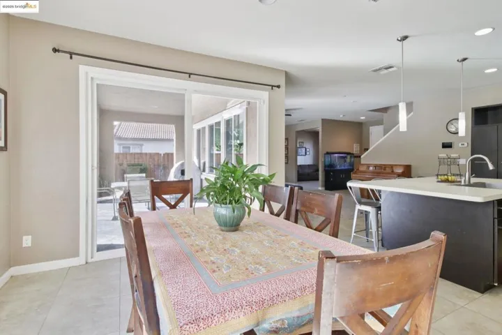 Dining space with light tile patterned floors and recessed lighting