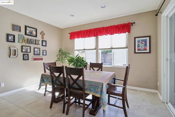 Dining area featuring light tile patterned flooring and baseboards