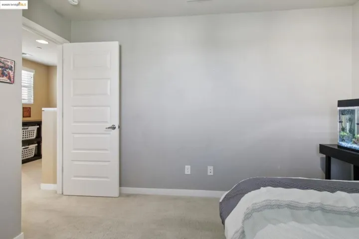 Bedroom featuring light colored carpet and baseboards