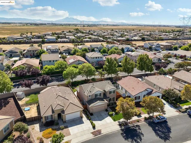Aerial perspective of suburban area with a mountainous background