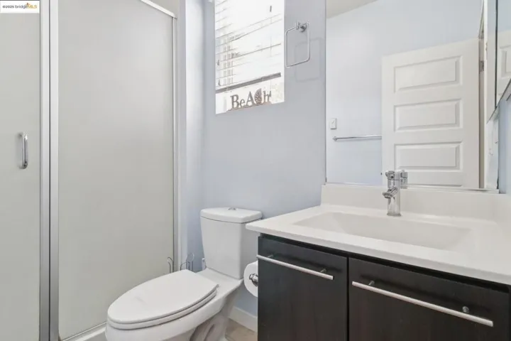 Full bathroom with vanity and a shower stall