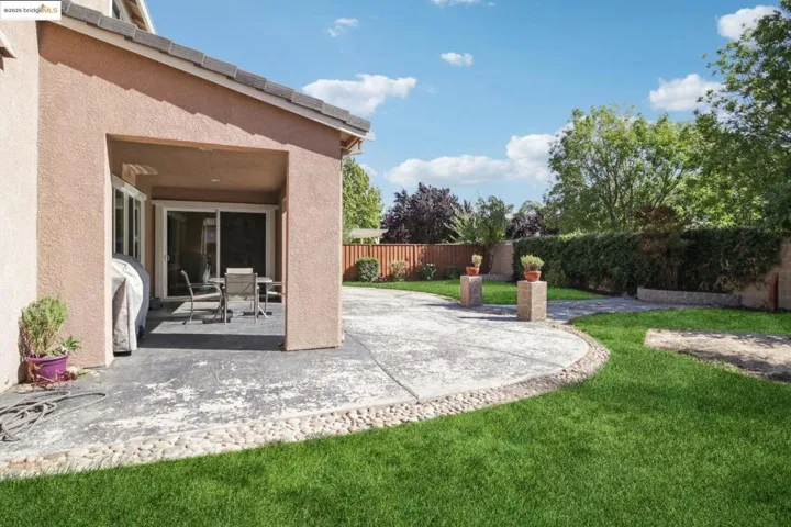 Fenced backyard with a patio