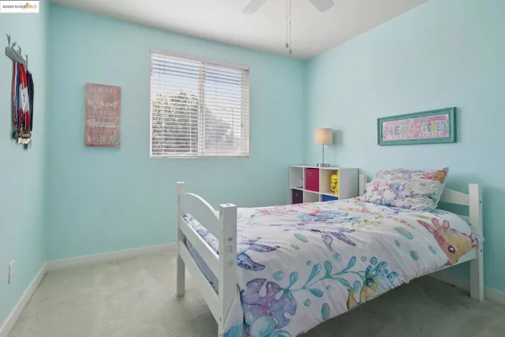 Carpeted bedroom with baseboards and ceiling fan