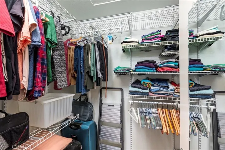 Portion of primary bedroom closet.