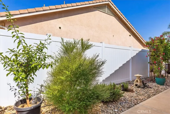 Side yard with new vinyl fence.