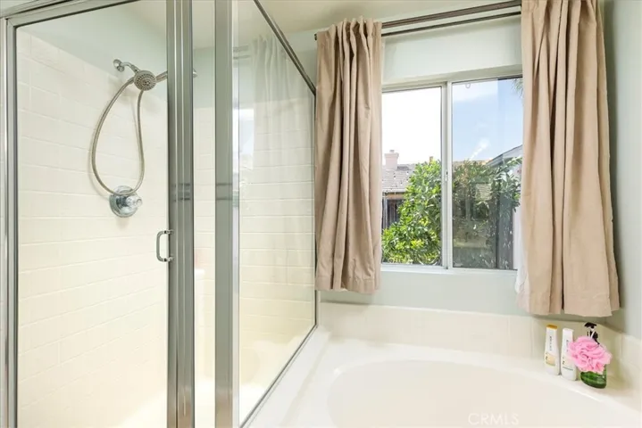 Primary bath includes separate tub and shower.