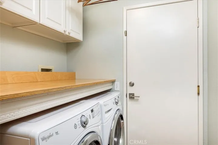 Indoor laundry with door out to 3 car garage.