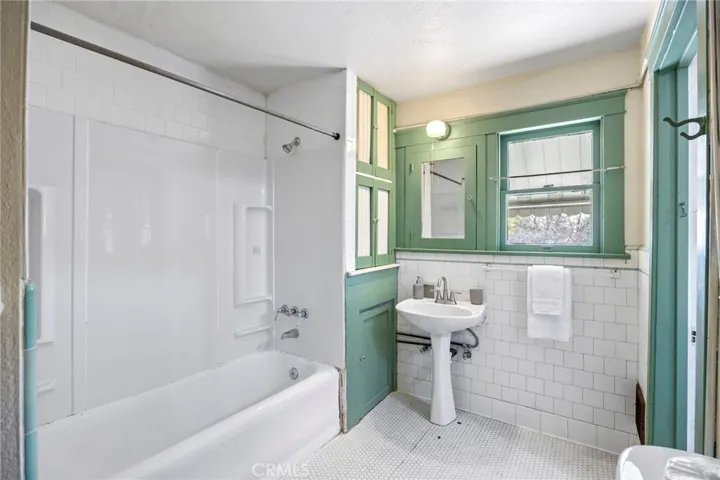 The upstairs bathroom with original floor tile