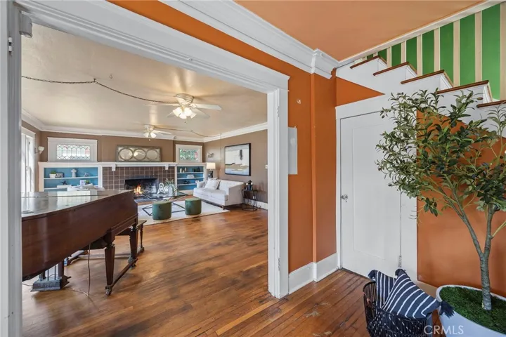 Formal Entry into the Living Room with Original Fireplace tiles and Stained Glass windows.