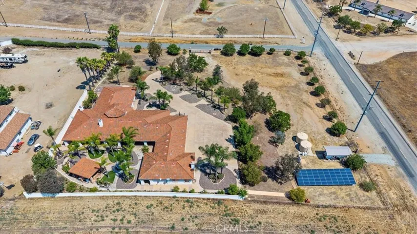 Drone Shot 2, Facing north, (Note the large Solor Array, twin 2500 gal Water Tanks, plus Covered R/V Parking)
