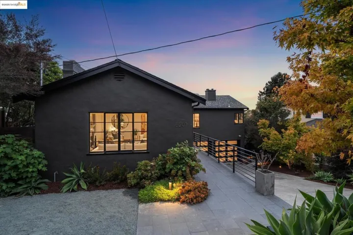 View of front of property with a chimney, stucco siding, and a patio