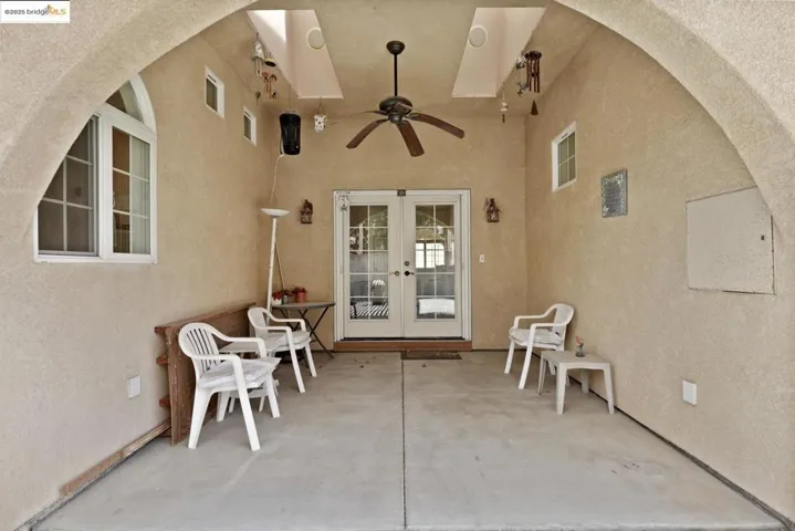 View of patio / terrace featuring ceiling fan and french doors