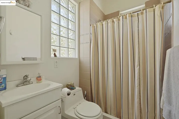 Full bath featuring vanity and a shower with shower curtain