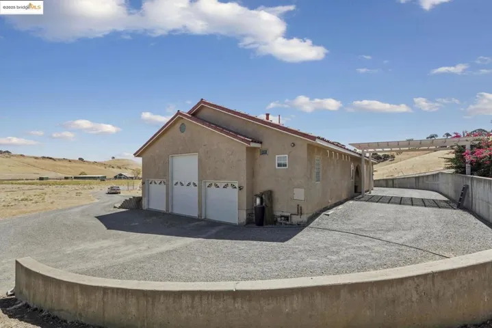 View of side of property with stucco siding and driveway