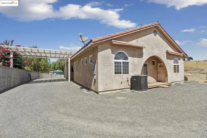 View of home's exterior featuring stucco siding and a cooling unit