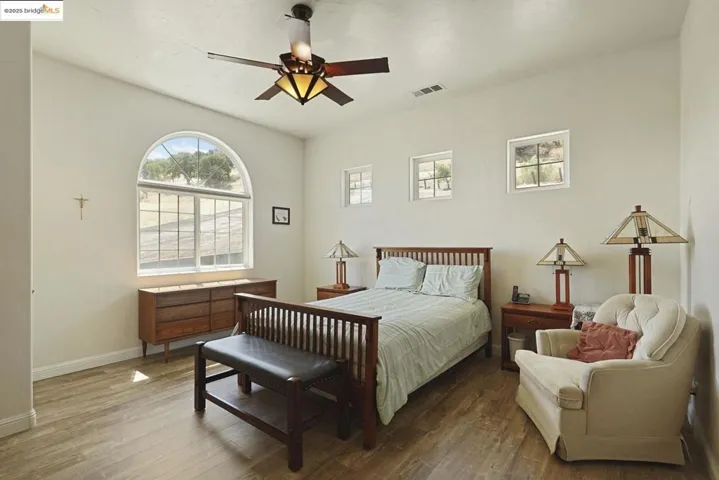 Bedroom featuring wood finished floors and ceiling fan