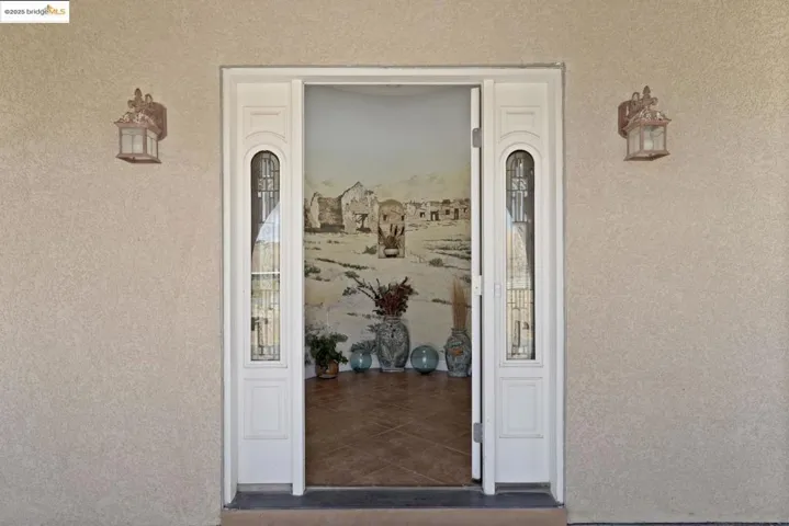 Property entrance featuring stucco siding