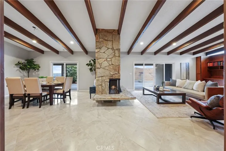 Full View of Formal Dining and Family Room with Beamed Ceilings