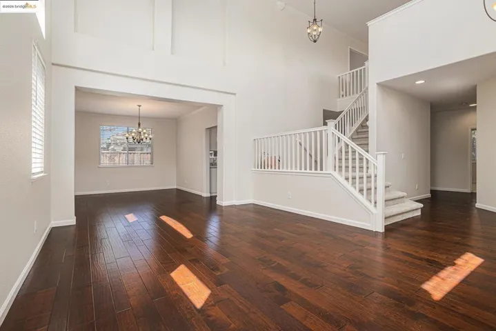 Towering ceiling, with crown molding and double sided stairs.
