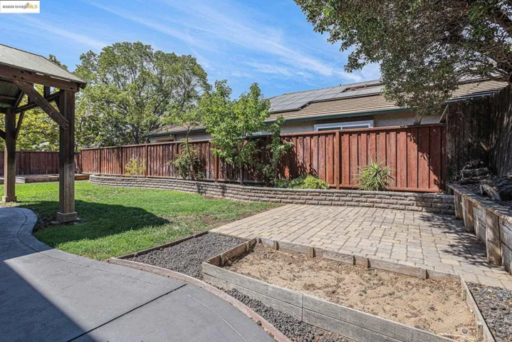 Fenced backyard with a patio area