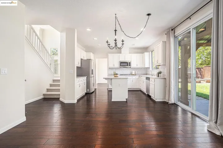 Kitchen with a center island, recess lighting, white cabinetry, backsplash, and a chandelier