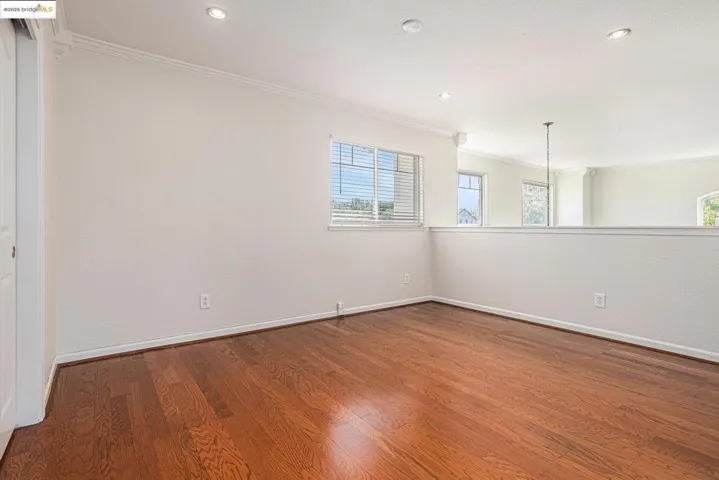 Optional 6th bedroom, with closet. Featuring ornamental molding, wood flooring, and recessed lighting