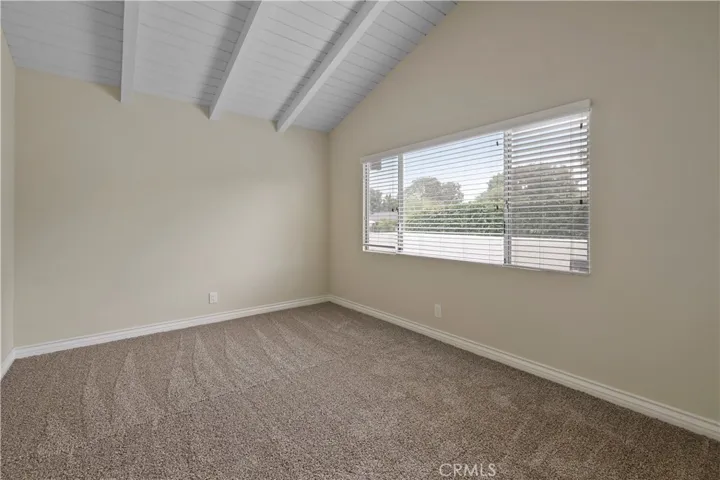 Third bedroom with high ceilings and greenbelt views.