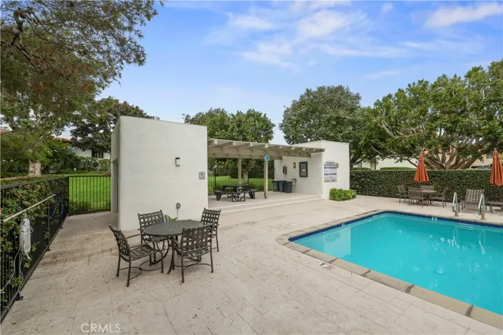 Pool has bbq and picnic tables for dining.