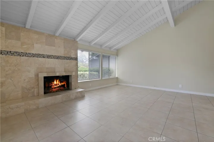 Large living room with cozy fireplace off the kitchen.