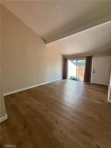 Spacious Living Room with high ceilings, lots of natural light, and sliding glass door to front patio area