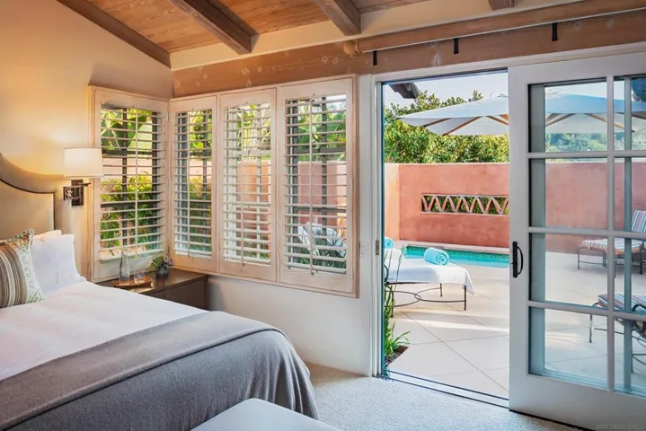 Primary bedroom has sliders opening to back patio where you will find jacuzzi, fire place and BBQ area