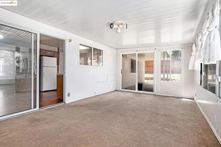 Unfurnished sunroom with healthy amount of natural light