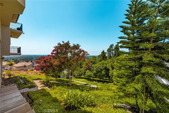 The lushly landscaped gently sloping yard is accessible from stairs to a meandering rock path leading to a gazebo. Mature trees provide shade, privacy and beauty!