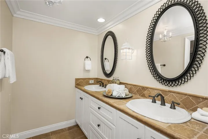 The lower level primary full bath features a vanity area separated from the tub/shower/toilet room.
