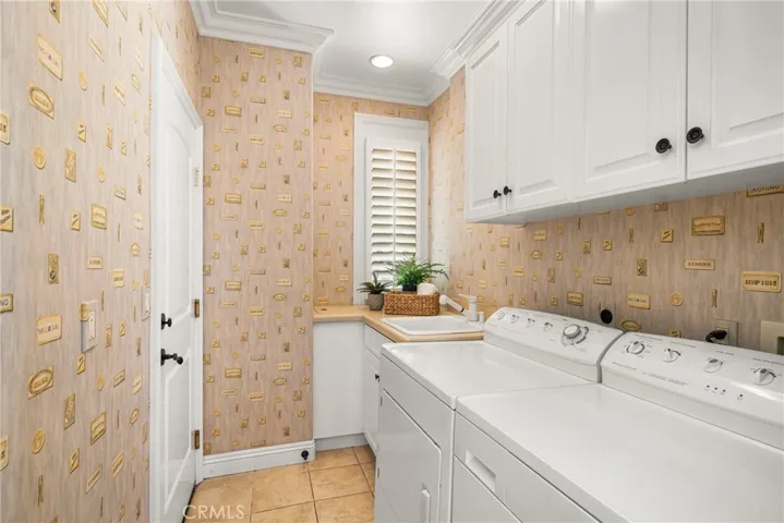 The laundry room (washer/dryer area included) has a sink, built-in hamper and direct access to the two-car garage.