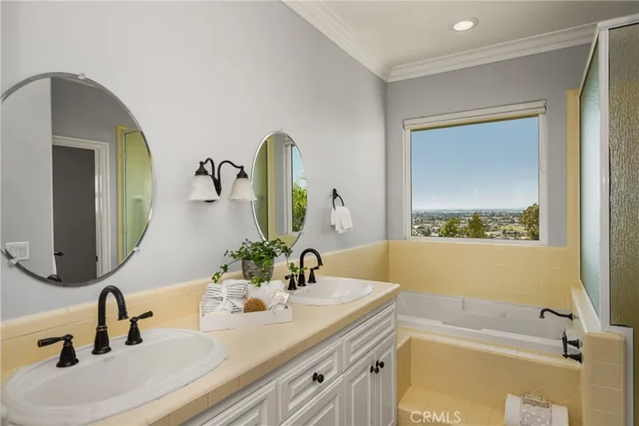 Enjoy the view while relaxing in the jetted tub!. Main level primary bath features dual sinks, a separate shower
and private toilet area.