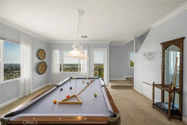 A spacious family room on the lower level includes a pool/game table where you can take in the views or retreat to another attached walk-out balcony.