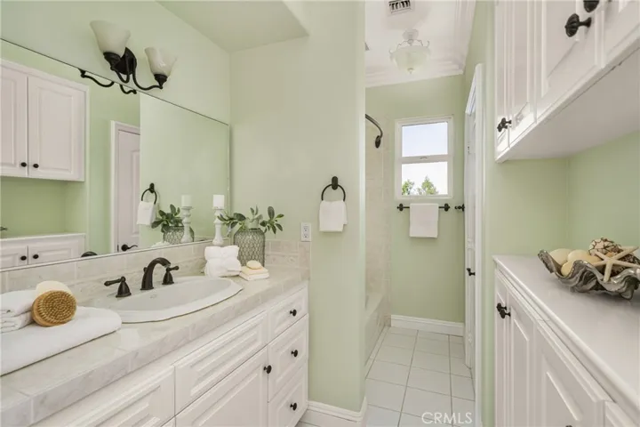 Third ensuite full bath with tub/shower and private toilet area.