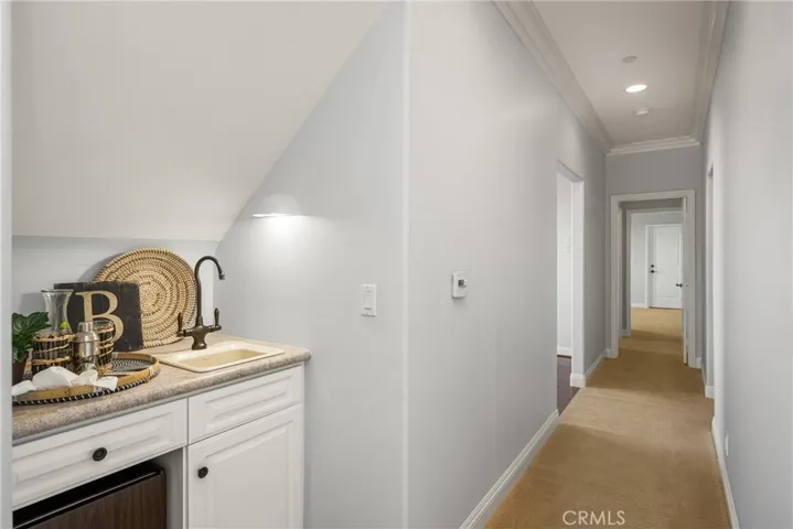 A wet bar with refrigerator is conveniently located next to the family/game room.